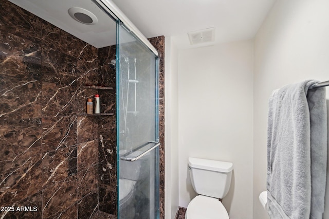 full bathroom featuring toilet, visible vents, and a stall shower