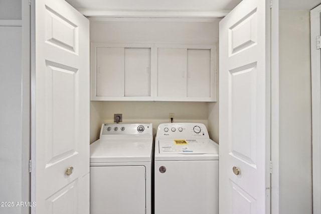 laundry area featuring cabinet space and washer and clothes dryer