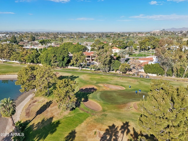 drone / aerial view with a water view and golf course view