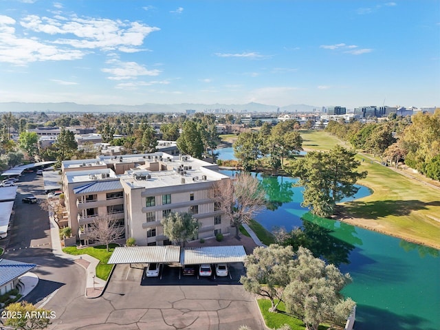 birds eye view of property featuring view of golf course and a water and mountain view