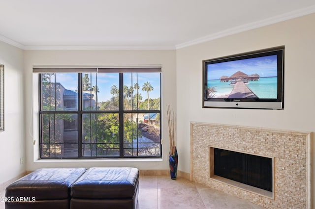 living room featuring baseboards, ornamental molding, tile patterned floors, and a fireplace