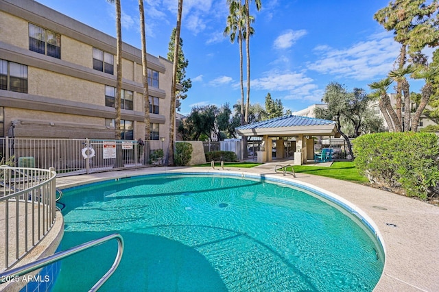 pool with fence and a gazebo