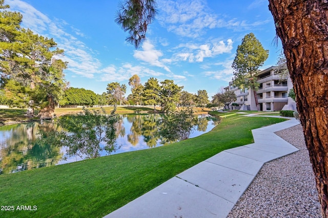 view of property's community featuring a yard and a water view