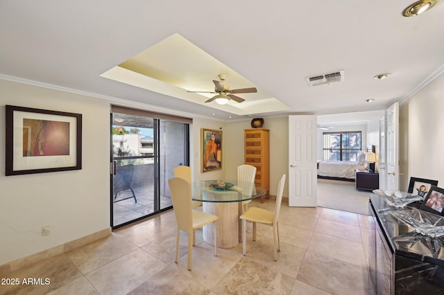 dining area with crown molding, baseboards, a wealth of natural light, and visible vents