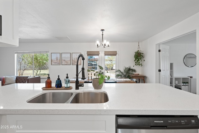 kitchen with a wealth of natural light, white cabinetry, dishwasher, and a sink