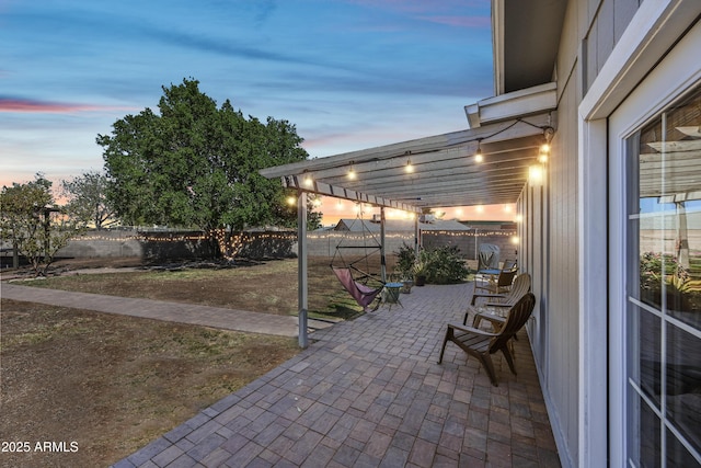 patio terrace at dusk with a fenced backyard