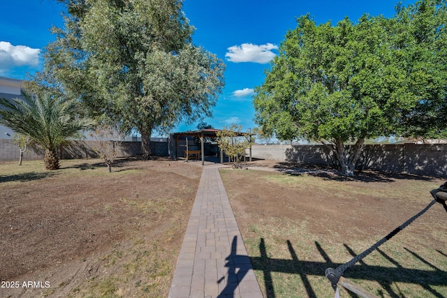 view of yard featuring a fenced backyard and an outbuilding