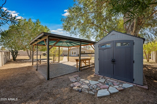 view of shed featuring a fenced backyard and a gazebo