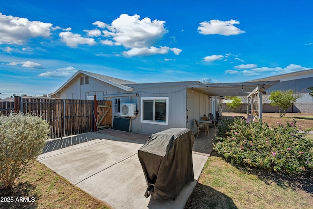 rear view of house with ac unit, a patio area, and fence