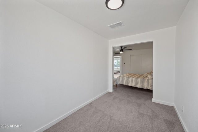 unfurnished bedroom featuring baseboards, visible vents, and carpet flooring