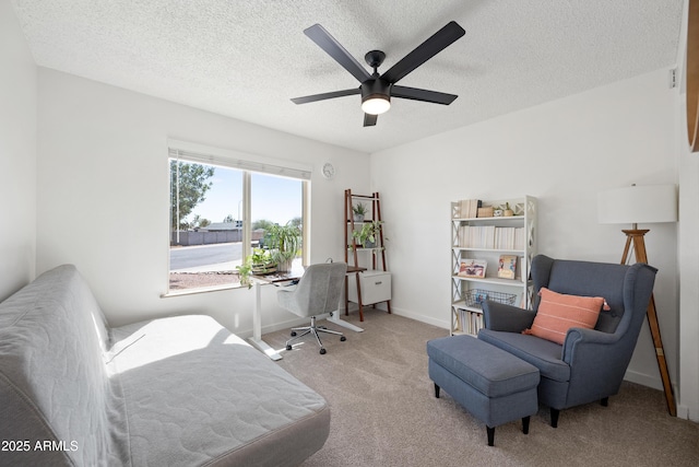 interior space with a textured ceiling, a ceiling fan, and baseboards