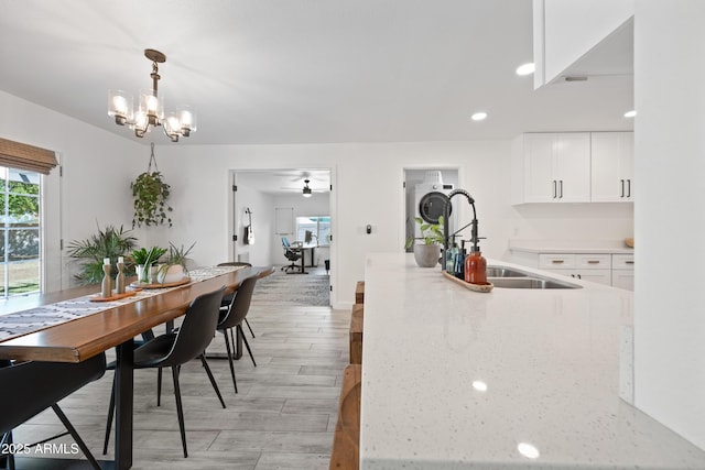 dining room with recessed lighting, light wood-style flooring, and ceiling fan with notable chandelier