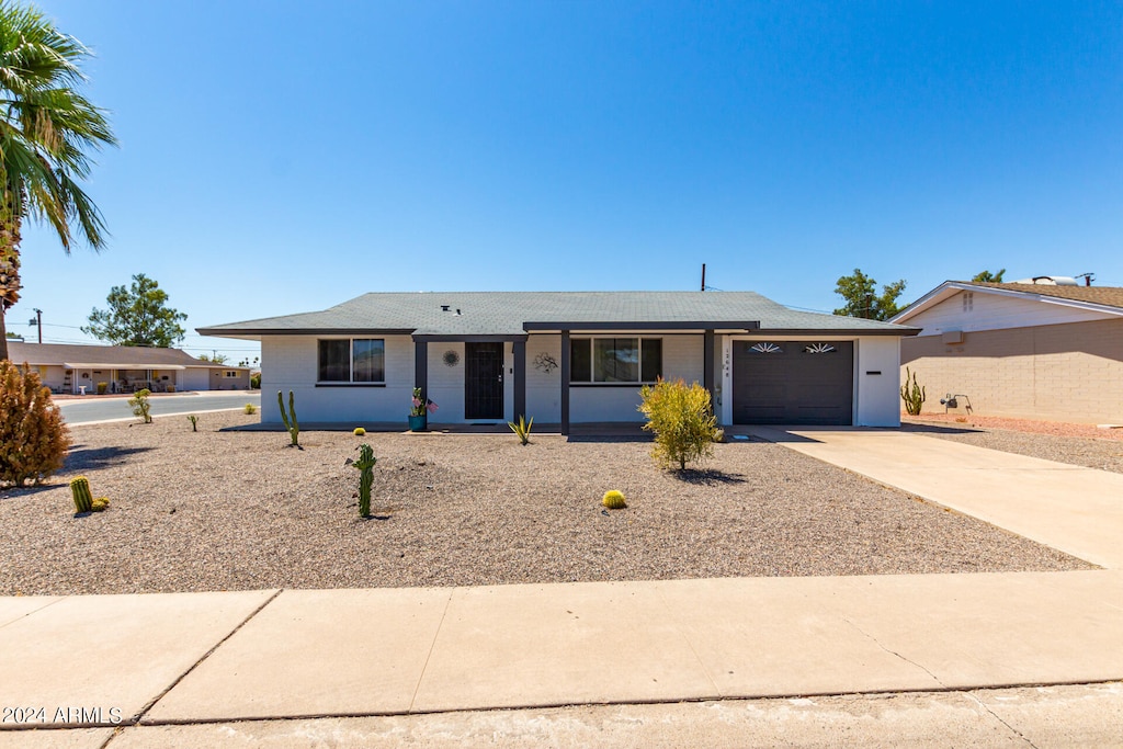 single story home with a garage and covered porch