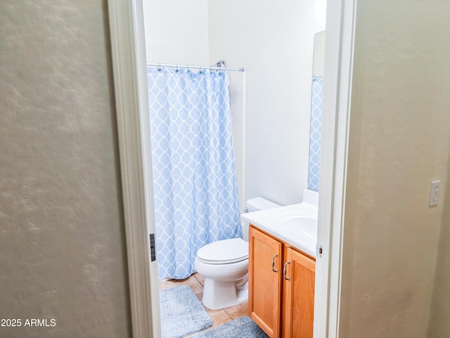 bathroom with a shower with curtain, tile patterned floors, toilet, and vanity