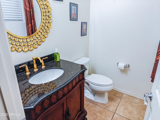 bathroom featuring tile patterned flooring, vanity, and toilet