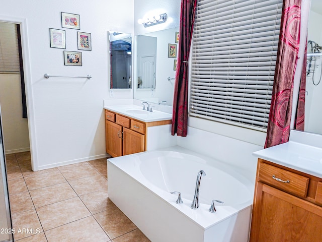 bathroom with vanity, a bath, and tile patterned floors