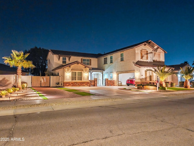 mediterranean / spanish-style home with a garage