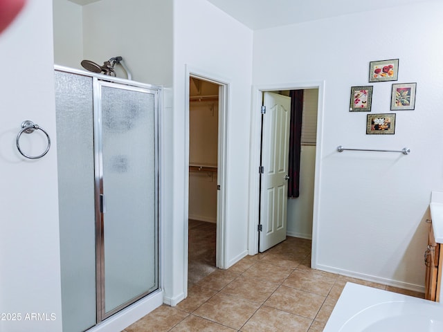 bathroom with tile patterned flooring and walk in shower