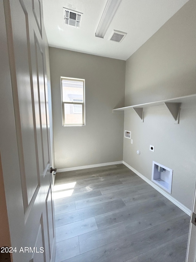 washroom with hookup for a washing machine, hookup for a gas dryer, hardwood / wood-style floors, and electric dryer hookup