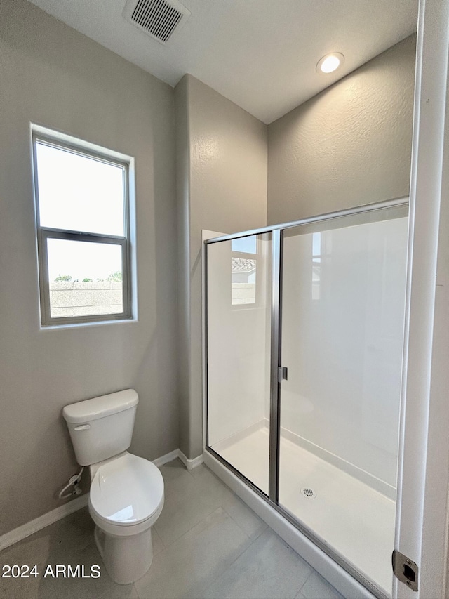 bathroom with toilet and walk in shower