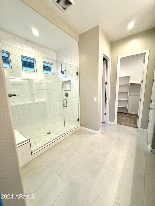 bathroom with a shower with door