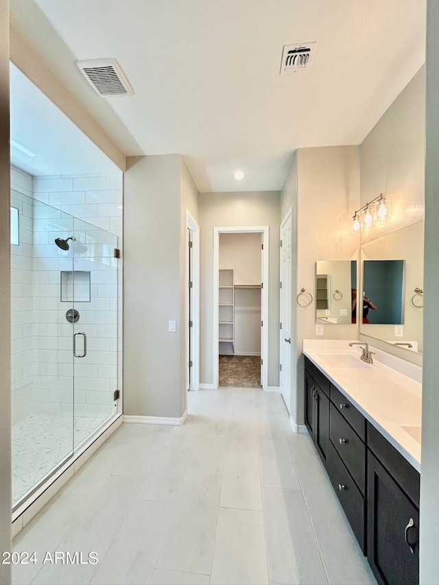 bathroom with tile patterned floors, an enclosed shower, and vanity