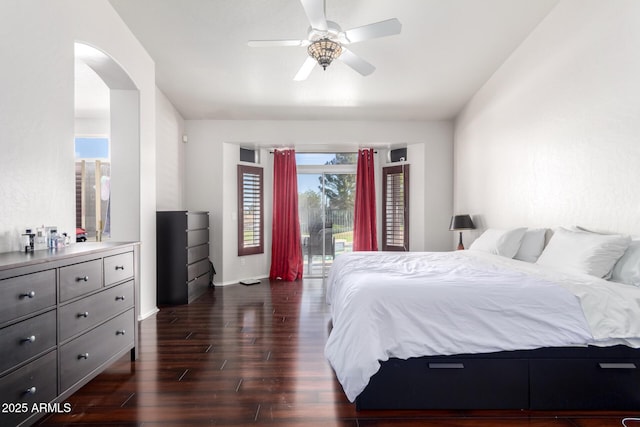 bedroom with multiple windows, access to outside, dark hardwood / wood-style floors, and ceiling fan