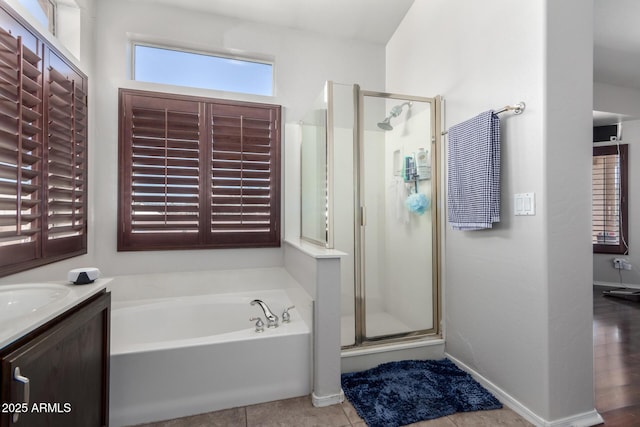 bathroom featuring tile patterned floors, vanity, and separate shower and tub