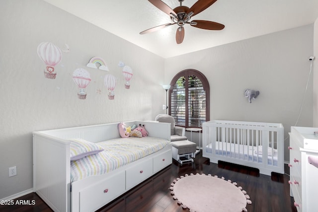 bedroom with ceiling fan and dark hardwood / wood-style flooring