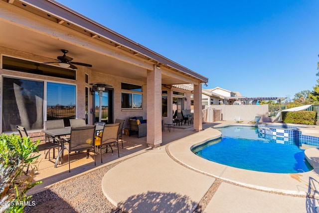 view of pool with ceiling fan and a patio