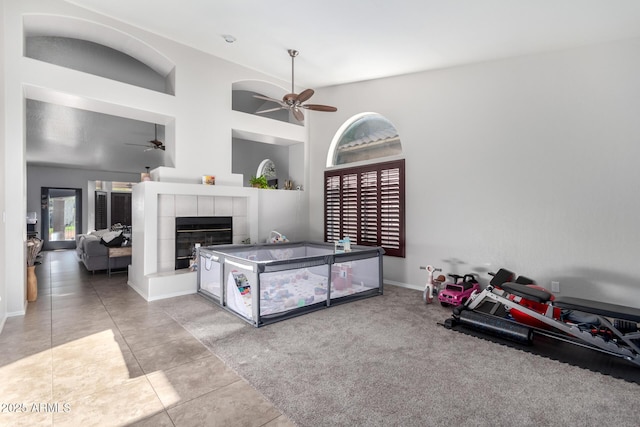 bedroom with light tile patterned flooring and a tile fireplace