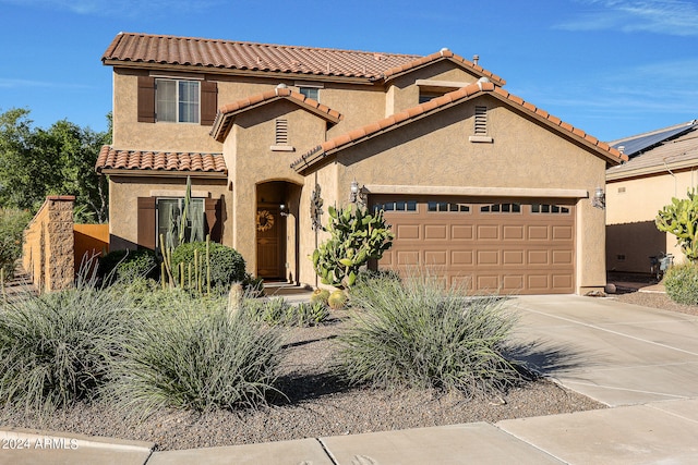 mediterranean / spanish-style house featuring a garage