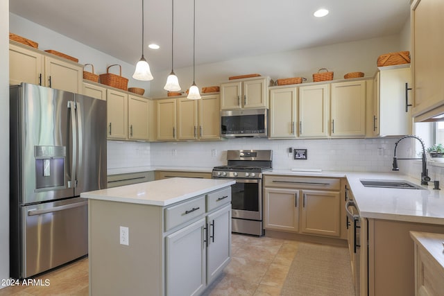 kitchen featuring pendant lighting, tasteful backsplash, sink, a kitchen island, and appliances with stainless steel finishes