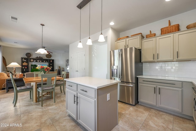 kitchen featuring gray cabinetry, tasteful backsplash, a center island, decorative light fixtures, and stainless steel fridge with ice dispenser