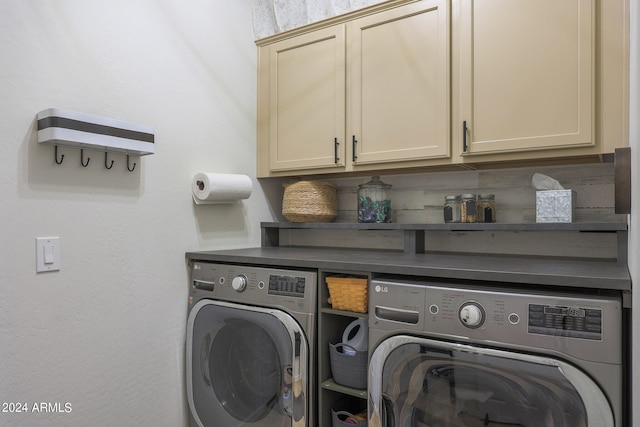 laundry room with washer and clothes dryer and cabinets