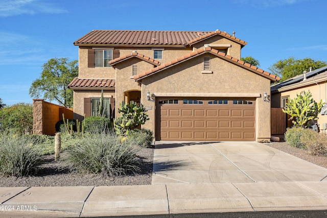 mediterranean / spanish-style house featuring a garage