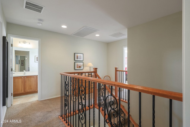 hall featuring light colored carpet