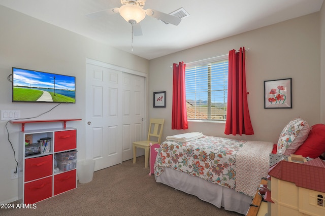 carpeted bedroom with ceiling fan and a closet