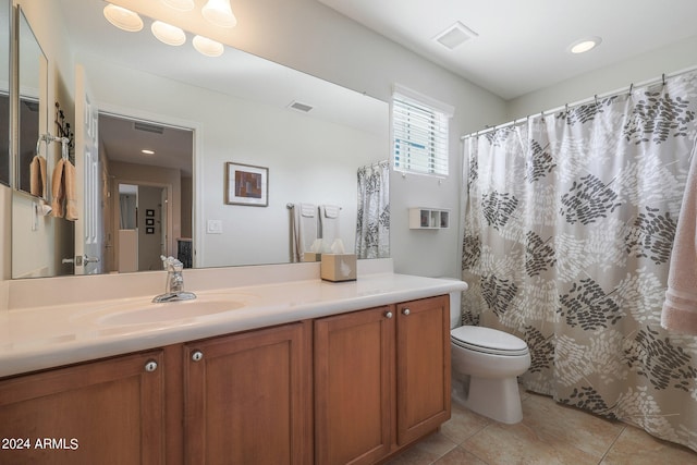 bathroom with vanity, toilet, and tile patterned floors