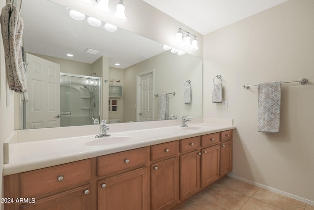 bathroom featuring tile patterned flooring, an enclosed shower, and vanity