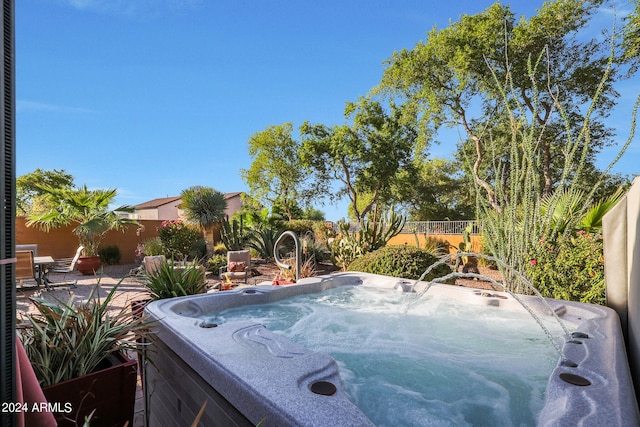 view of swimming pool with a hot tub and a patio