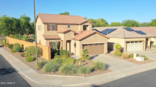 mediterranean / spanish-style house with a garage