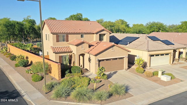 mediterranean / spanish house featuring a garage