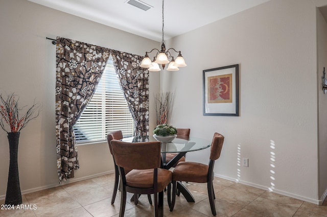 dining area featuring light tile patterned floors and a chandelier