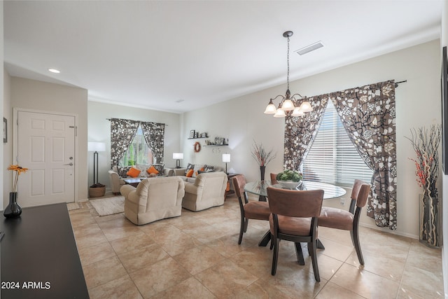 tiled dining area featuring an inviting chandelier