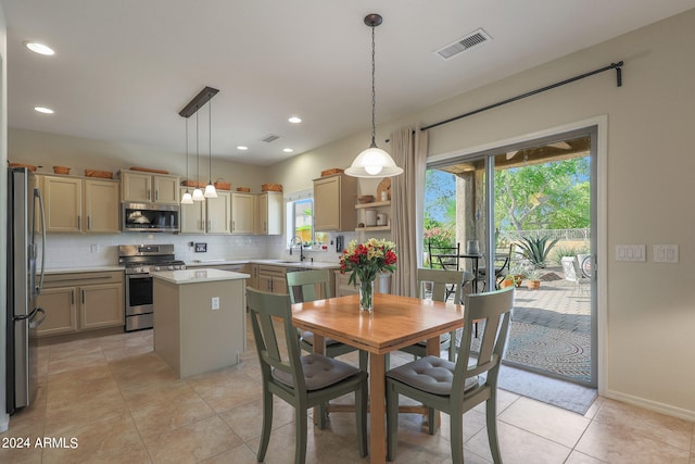 tiled dining room featuring sink