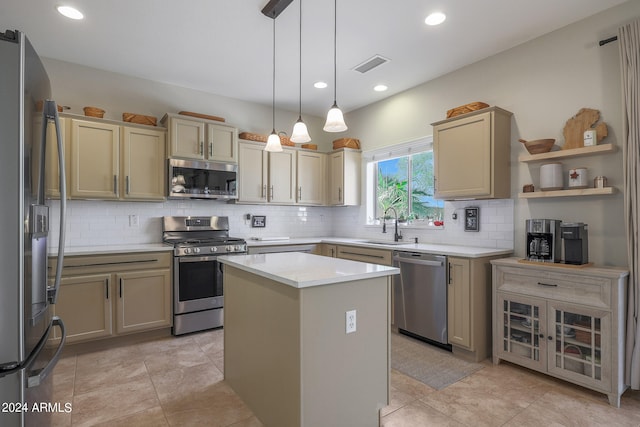 kitchen featuring pendant lighting, a center island, sink, stainless steel appliances, and backsplash