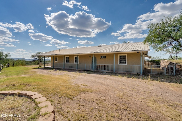 back of house featuring covered porch