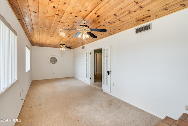 unfurnished room with ceiling fan, light colored carpet, french doors, and wooden ceiling