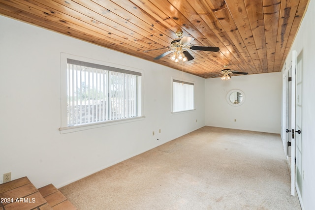 carpeted empty room featuring ceiling fan and wooden ceiling